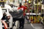 a technician uses a lift to move a back seat bench into a new Altima on the assembly line at the Nissan Canton Vehicle Assembly Plant in Canton